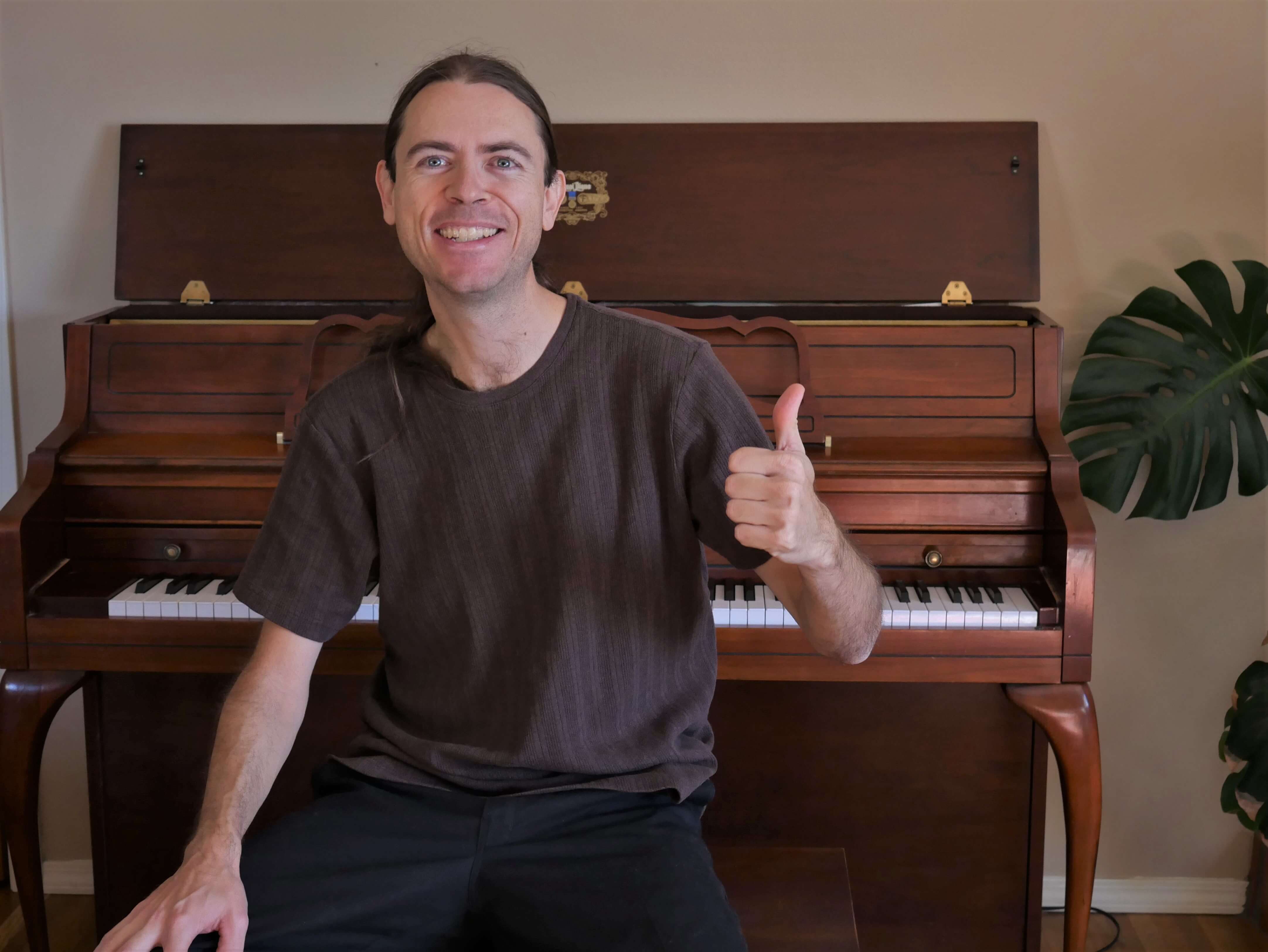 Instructor Nick smiling broadly and giving you a thumbs up!  Let's have fun working together to achieve your music goals!